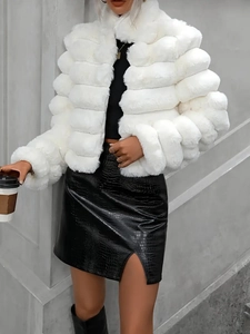 Detail of white faux fur jacket texture paired with black crocodile embossed leather skirt