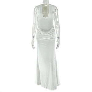 Detail of white sleeveless maxi dress with deep V-neck and ruched bodycon design