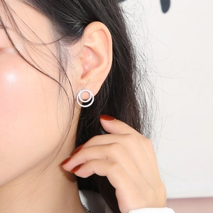Silver multilayer circular zircon stud earrings shown on model for clear visual scale