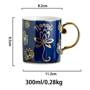 Close-up of dark blue ceramic mug with gold Namaste text, lotus design and handle