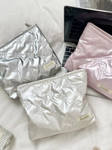 Quilted heart PU leather makeup bag in silver, cream, and pink with a metal zipper