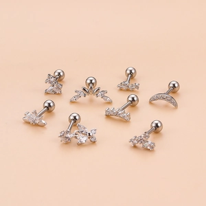 Silver stainless steel stud earrings set with butterfly and zircon designs on beige background