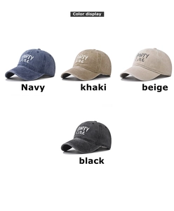Close-up of four washed cotton baseball caps in navy, khaki, beige and black colors