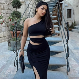 Detail of black one-shoulder dress showing waist cut-out and high side slit on skirt