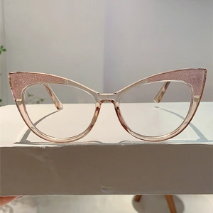 Detail of cat-eye glasses frame with pink glitter accents and rose pink transparent resin