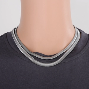 Close-up of double layer silver stainless steel flat snake chain worn by a model