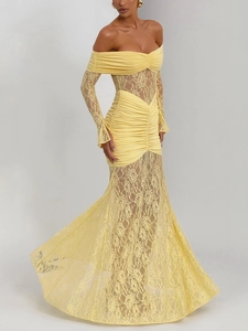 Detail of yellow off-shoulder dress featuring intricate lace embroidery and ruffled waist