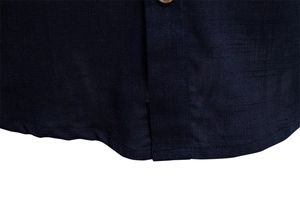 Macro detail of dark blue men's shirt showing breathable linen-like texture and fine stitching