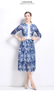 Detailed close-up of blue floral lace embroidery and white hollow-out waist trim