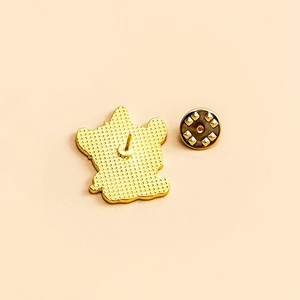 Golden unicorn alloy brooch back view with butterfly clasp on beige background