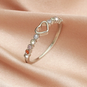 Macro detail of silver open heart ring with multi-colored round cubic zirconia stones
