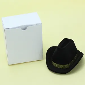 Miniature black cowboy hat jewelry box with gold trim and white foldable gift packaging