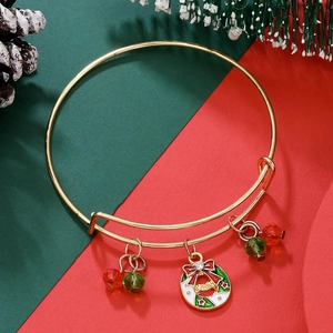 Close-up of adjustable Christmas bracelet with red and green beads and enamel bell charm