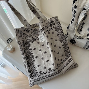 Detail of bandana paisley print canvas tote bag with a minimalist woven label