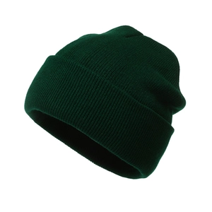 Close-up of dark green knitted beanie showing fine texture and ribbed cuff detail
