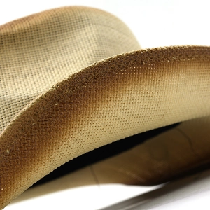 Macro view showing detailed cross-weave texture of a Western straw cowboy hat