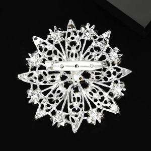 Back view of silver hollow sun flower brooch showing pin mechanism and craftsmanship