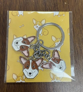 Close-up of three cute Corgi dog alloy charms on a DIY keychain with card packaging