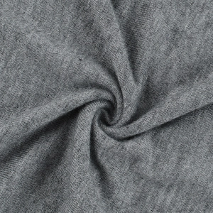 Macro view of gray textured knitted fabric showing soft wool-like textile texture