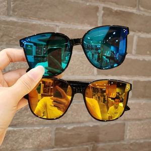 Detail of kids square sunglasses set with vibrant blue-green and orange-yellow mirrors