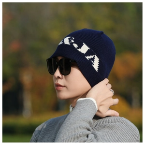 Close-up of navy knit beanie featuring white contrast lettering and soft wool texture
