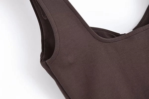Detail shot of dark brown fabric showing precise double-stitched edging and dense texture