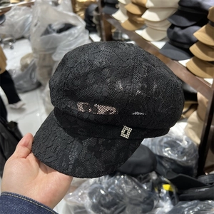 Detail of black lace newsboy cap with a sparkling silver square rhinestone buckle ornament
