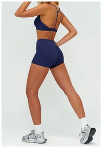 Side-rear view of navy high waist yoga shorts and sports bra set for women