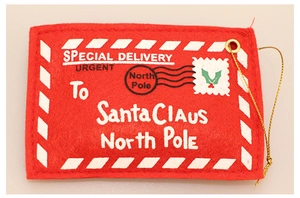 Detail of red felt Christmas envelope ornament with gold string and festive text