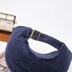 Deep blue washed cotton baseball cap with adjustable bronze metal buckle back detail