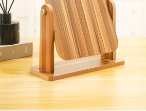 Detail view of the wooden vanity mirror featuring adjustable stand and natural wood grain