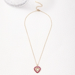 Detailed view of heart pendant necklace with pink and white cubic zirconia stones