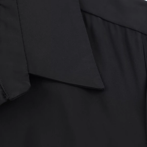 Detailed close-up of the black shirt midi dress collar and premium fabric texture