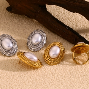 Detailed set of wheat-patterned gold and silver earrings with matching pearl ring