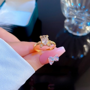 Macro detail of gold-plated bear ring featuring heart-shaped cubic zirconia and pavé stones