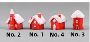 Detailed view of four red and white miniature resin Christmas houses with faux snow roofs
