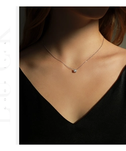 Close-up of elegant S925 sterling silver necklace with a 0.8ct moissanite pendant on neck