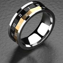 Close-up of black and gold stainless steel ring with engraved Roman numerals
