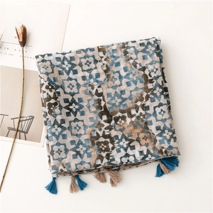 Detail of blue and brown geometric print scarf with dual-color tassel edges