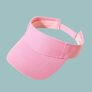 Detail of a pink sun visor baseball cap showing twill cotton texture and adjustable strap