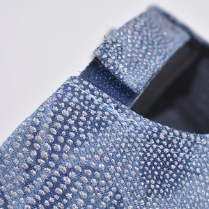 Macro detail of blue fabric baseball cap with silver glitter and stitch craftsmanship