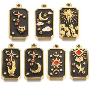 Set of tarot-style stainless steel charms with golden celestial motifs on black enamel