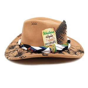 Detail of brown wool felt cowboy hat featuring peacock flower print and feather decor