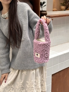 Detail of soft purple plush thermal cup carrier bag with cartoon patch and thick handle
