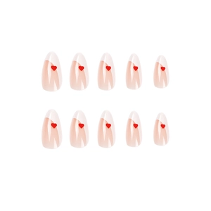 Press-on nails featuring white French tips and red heart patterns on almond shape