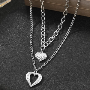 Double-layer stainless steel necklace featuring silver heart pendants and angel wing charms