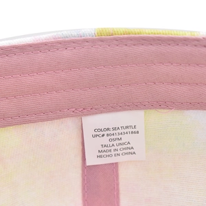 Macro shot of pink sweatband and sizing tag inside a colorful tie-dye baseball cap