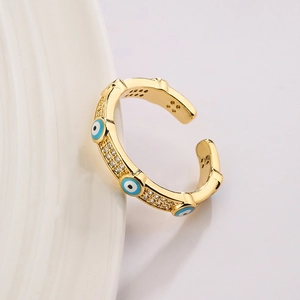 Gold plated evil eye open ring with blue enamel and cubic zirconia on white background