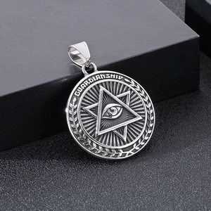 Macro detail of silver Eye of Providence pendant featuring GUARDIANSHIP engraving