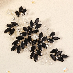 Macro view of handmade black crystal and pearl bridal hair comb with silver wire flowers